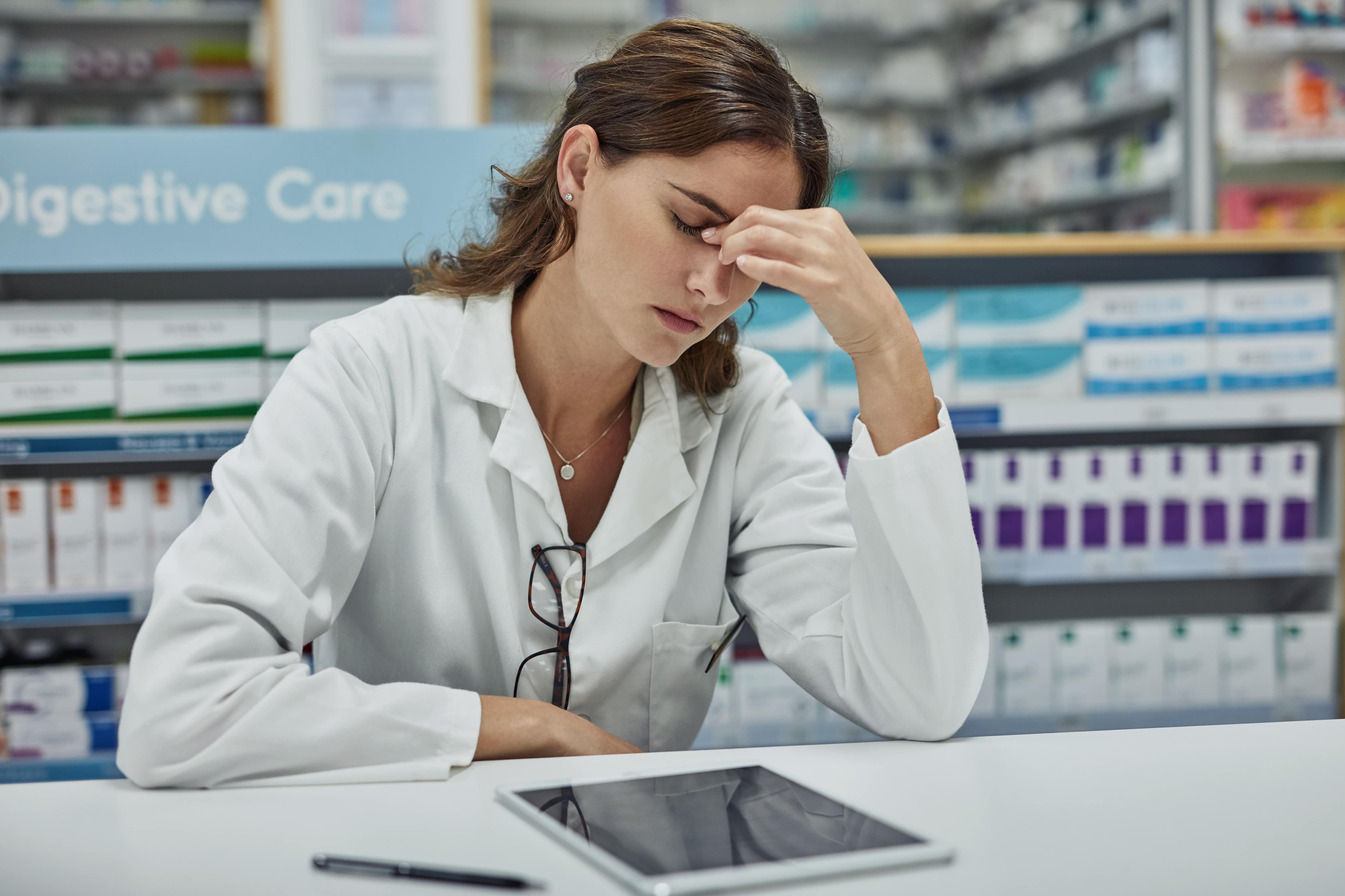 Frustrated physician at desk with EMR software